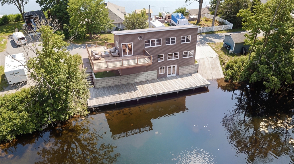 a view of swimming pool with outdoor seating and lake view