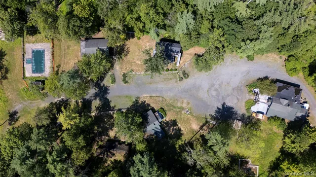an aerial view of a house with a yard
