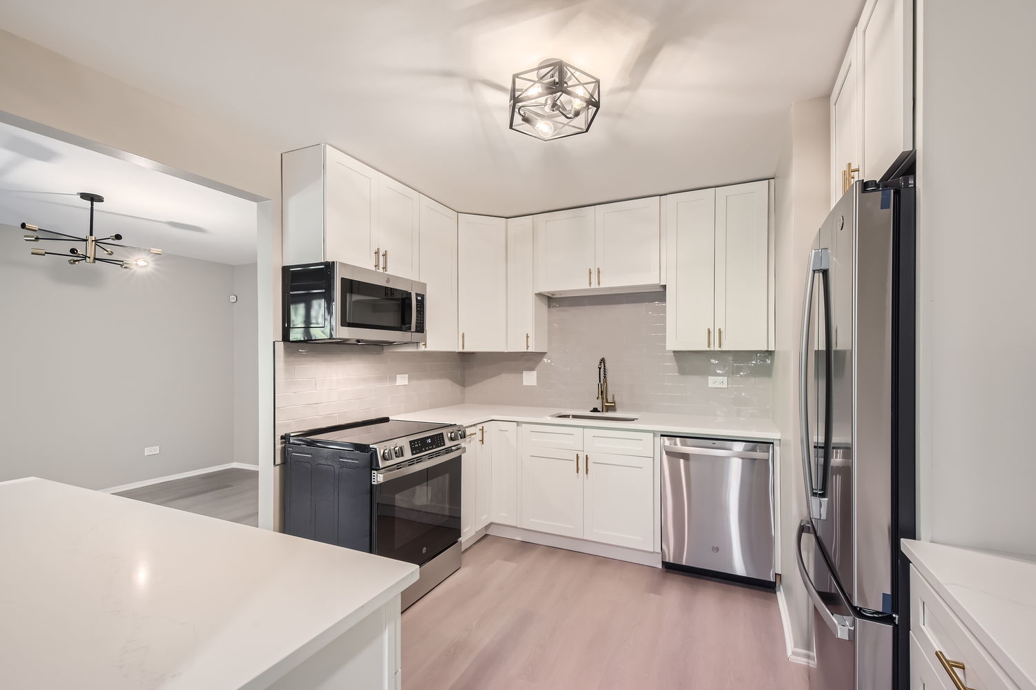 1060 Shermer Road, Unit 26 Northbrook, IL 60062 - Photo 5 of 17 a kitchen with stainless steel appliances a sink a stove a microwave and cabinetry