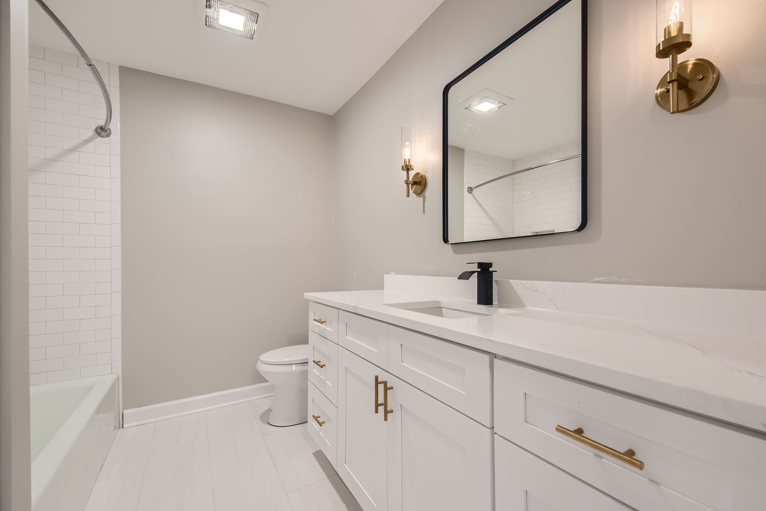 1060 Shermer Road, Unit 26 Northbrook, IL 60062 - Photo 9 of 17 a bathroom with a granite countertop sink a toilet and mirror