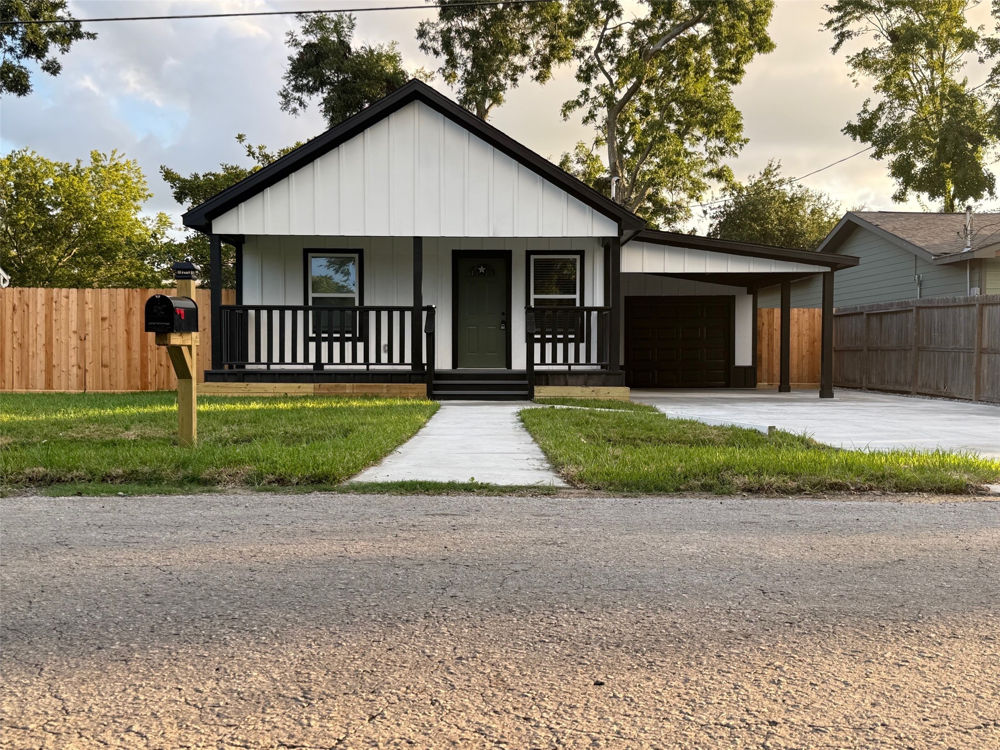 14213 4th Street Santa Fe, TX 77517 - Photo 1 of 20 a front view of a house with a yard and garage