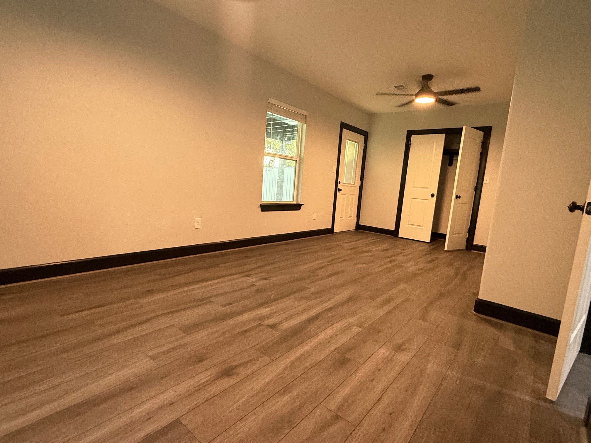 14213 4th Street Santa Fe, TX 77517 - Photo 11 of 20 an empty room with wooden floor and windows