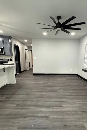 a view of a kitchen with a sink and a refrigerator