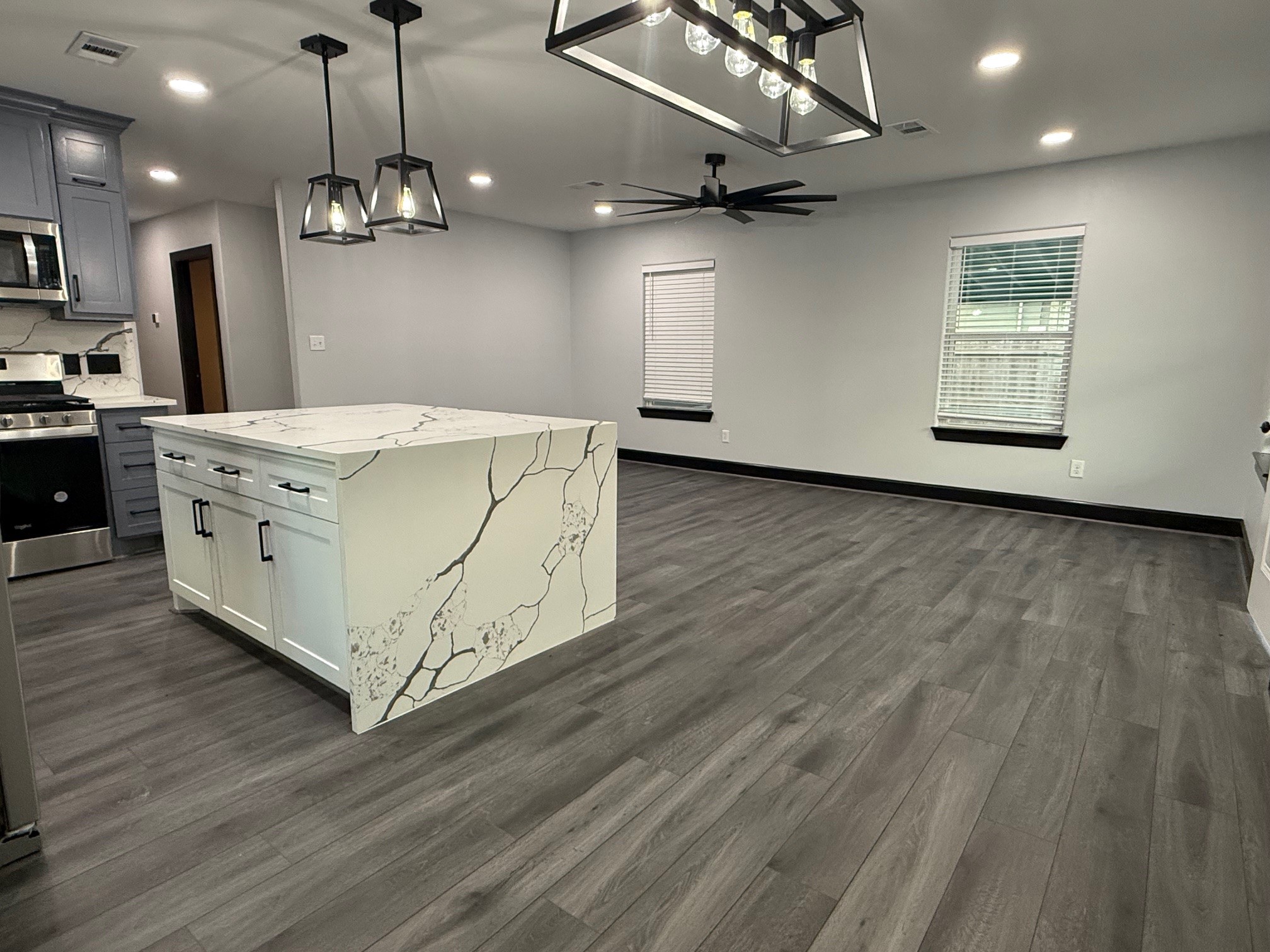 14213 4th Street Santa Fe, TX 77517 - Photo 4 of 20 a kitchen with stainless steel appliances granite countertop a sink a stove and a wooden floors