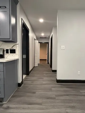 a view of a hallway with wooden floor