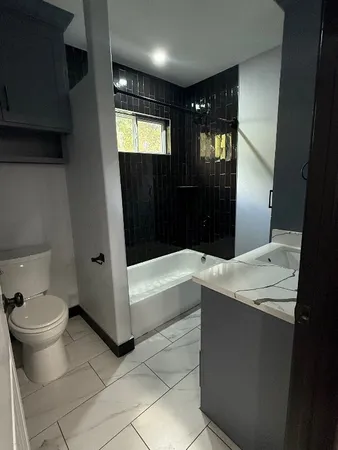 a bathroom with a bathtub and a toilet