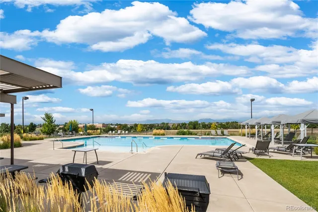 a view of a lake with couches and city view