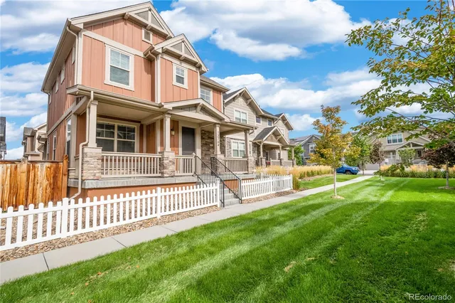 a front view of a house with a yard table and chairs