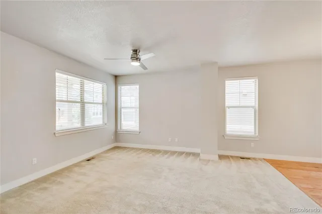 an empty room with windows and closet