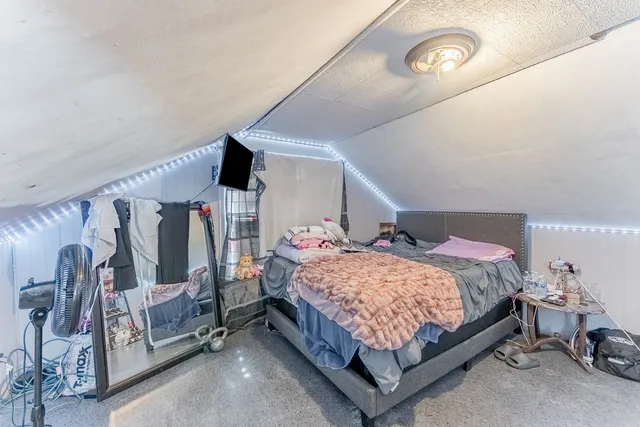 a bedroom with a bed and a walk in closet