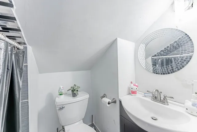 a bathroom with a sink mirror toilet and bathtub