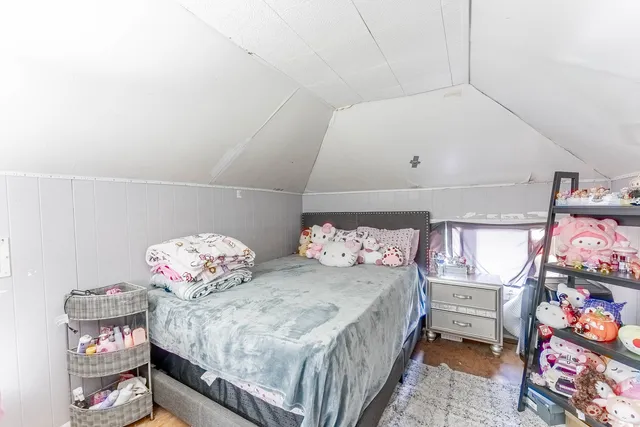 a bedroom with bed and a chandelier