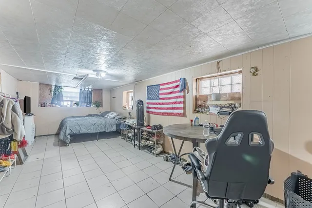 a bedroom with furniture and a window