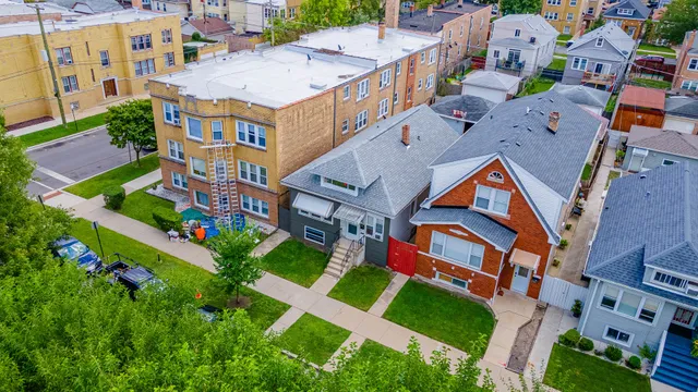 an aerial view of multiple houses with yard