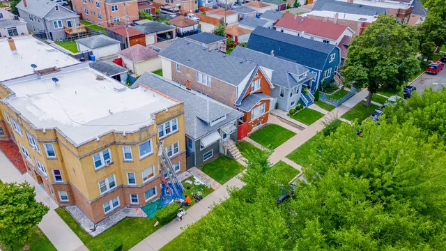 an aerial view of residential houses with outdoor space and street view