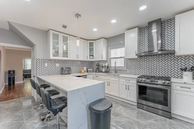 a kitchen with a sink stove and cabinets