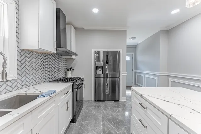 a kitchen with a sink stove and refrigerator