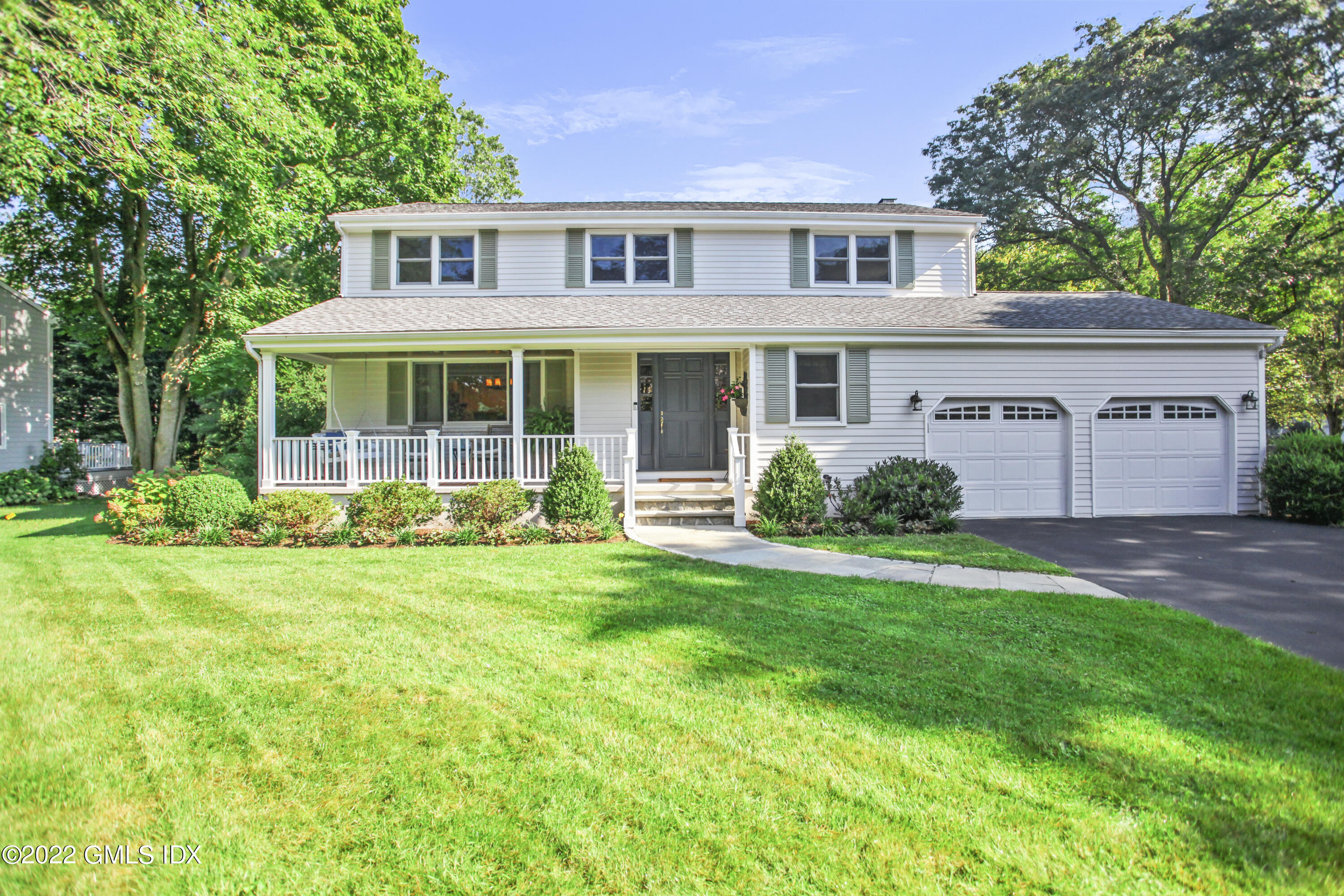 23 Split Timber Place Riverside, CT 06878 - Photo 3 of 32 a front view of a house with a yard and potted plants