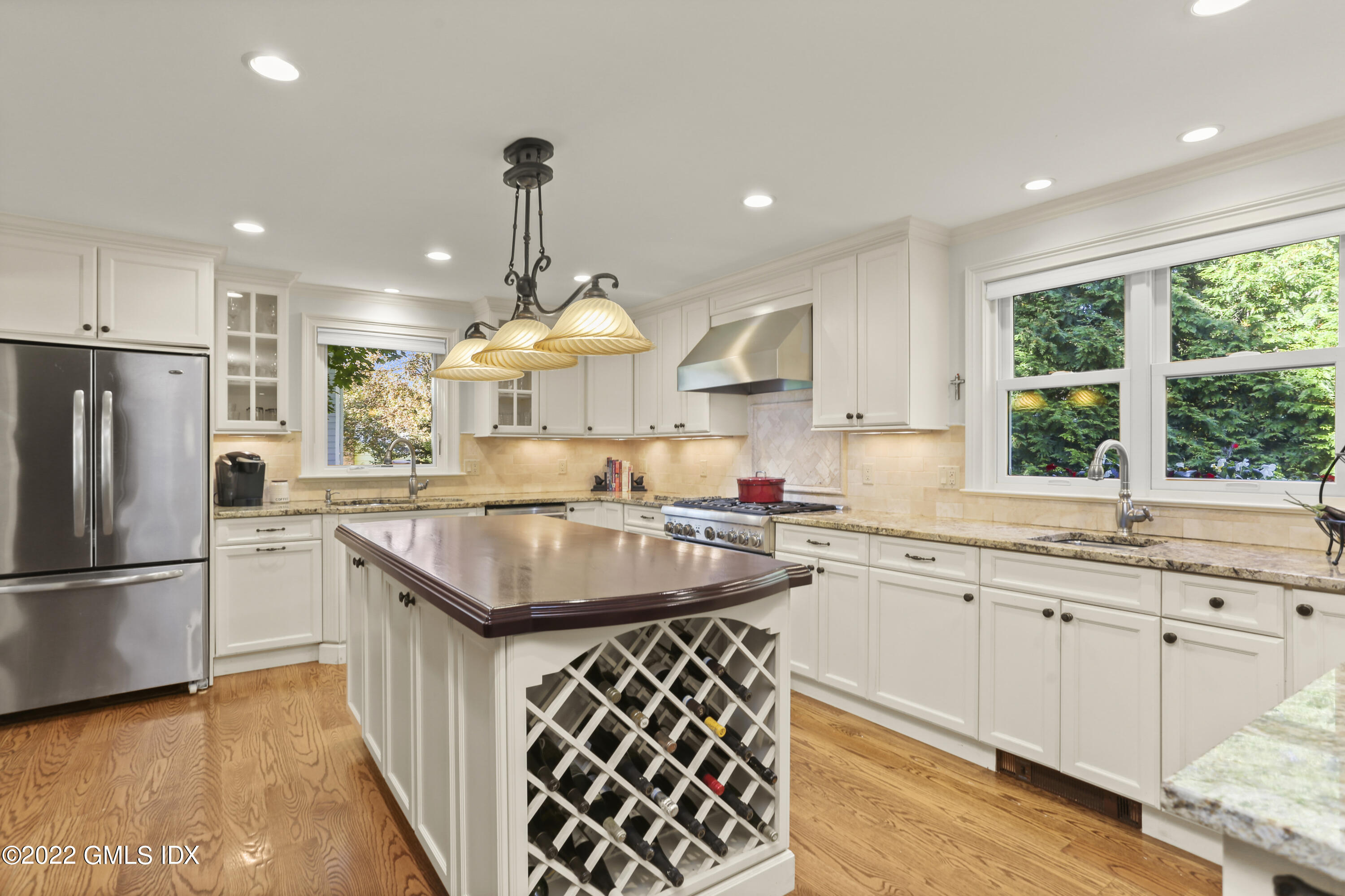 23 Split Timber Place Riverside, CT 06878 - Photo 7 of 32 a kitchen with stainless steel appliances granite countertop a sink a stove a refrigerator and island with wooden floor
