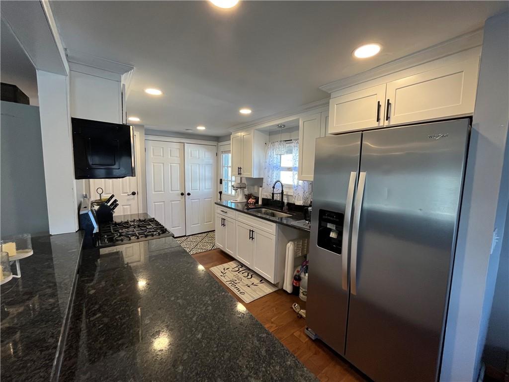 683 10 Mile Road Amity, PA 15311 - Photo 4 of 16 a large white kitchen with a refrigerator a fireplace and a flat screen tv
