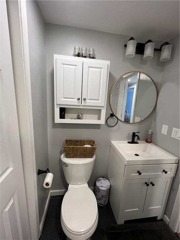 683 10 Mile Road Amity, PA 15311 - Photo 10 of 16 a bathroom with a toilet a sink and mirror