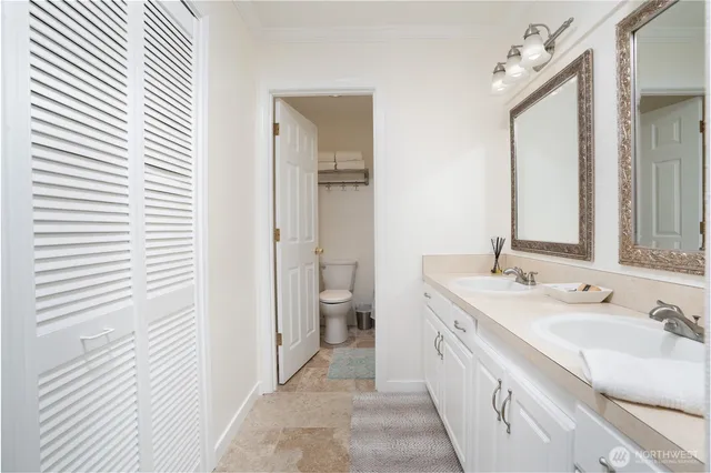 a spacious bathroom with a double vanity sink and a mirror