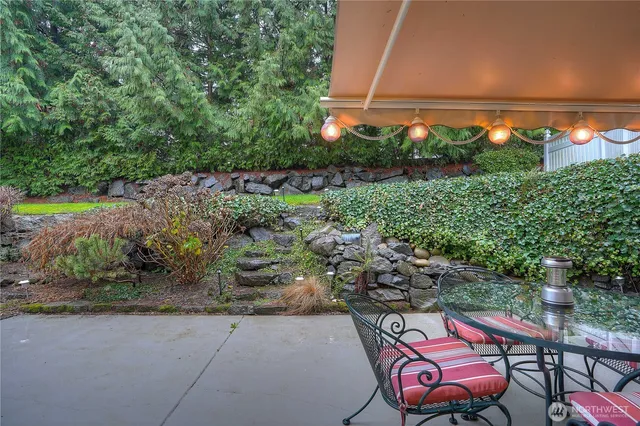 a backyard of a house with yard and outdoor seating