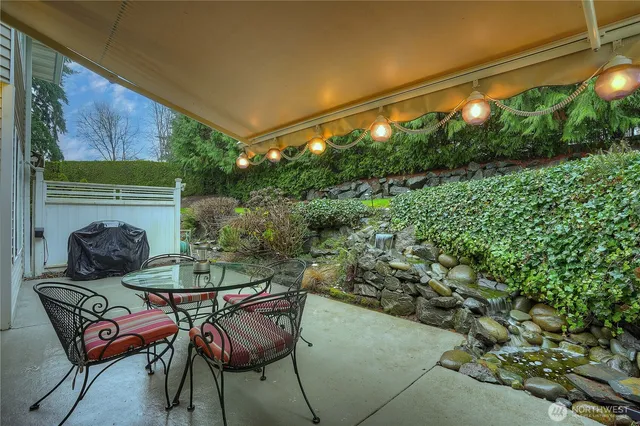 a backyard of a house with table and chairs