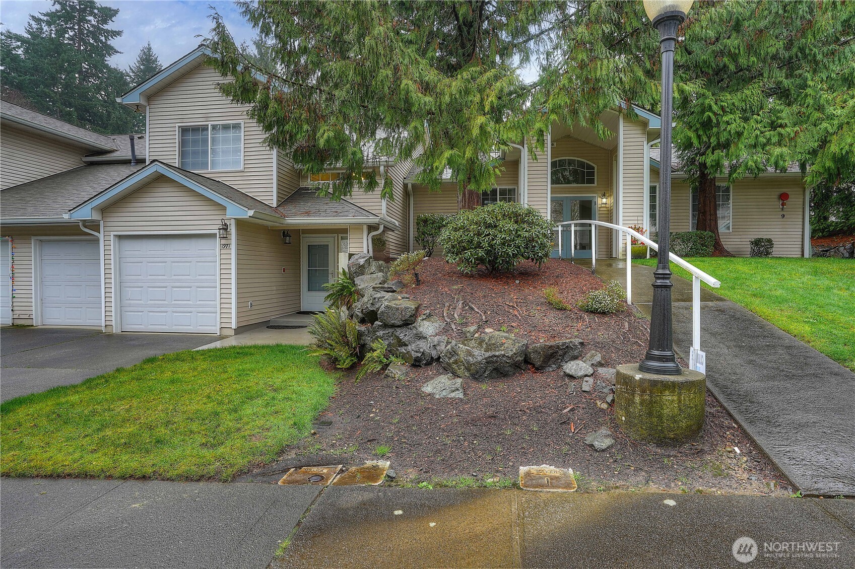 1971 South 368th Place, Unit 902 Federal Way, WA 98003 - Photo 3 of 39 a front view of a house with a garden