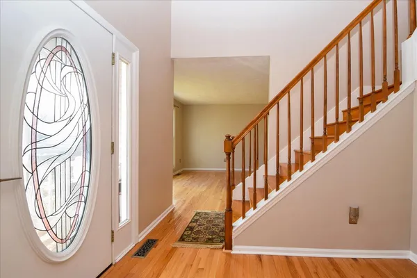 a view of front door with wooden floor