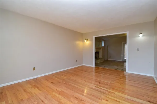 a view of an empty room and wooden floor