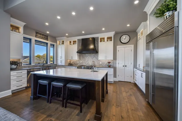 a bathroom with a sink a toilet a mirror and shower
