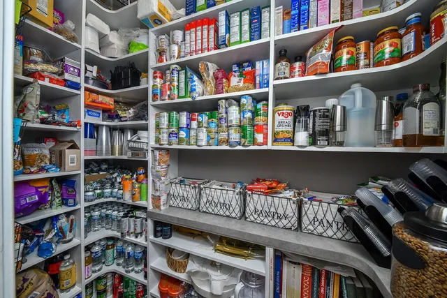 a spacious bedroom with a bed and a flat screen tv