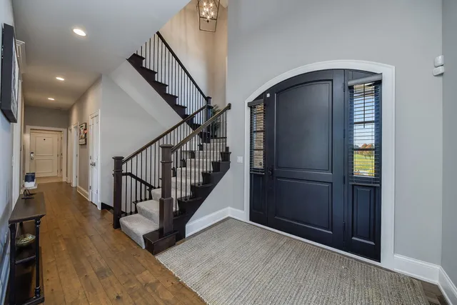 a view of entryway with wooden floor and stairs