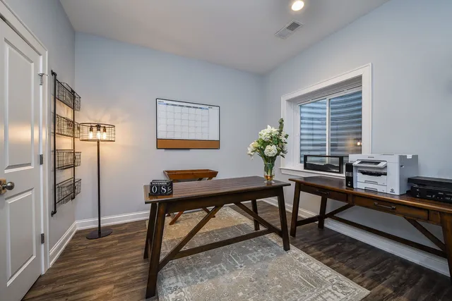 a view of a swimming pool with a yard and wooden fence