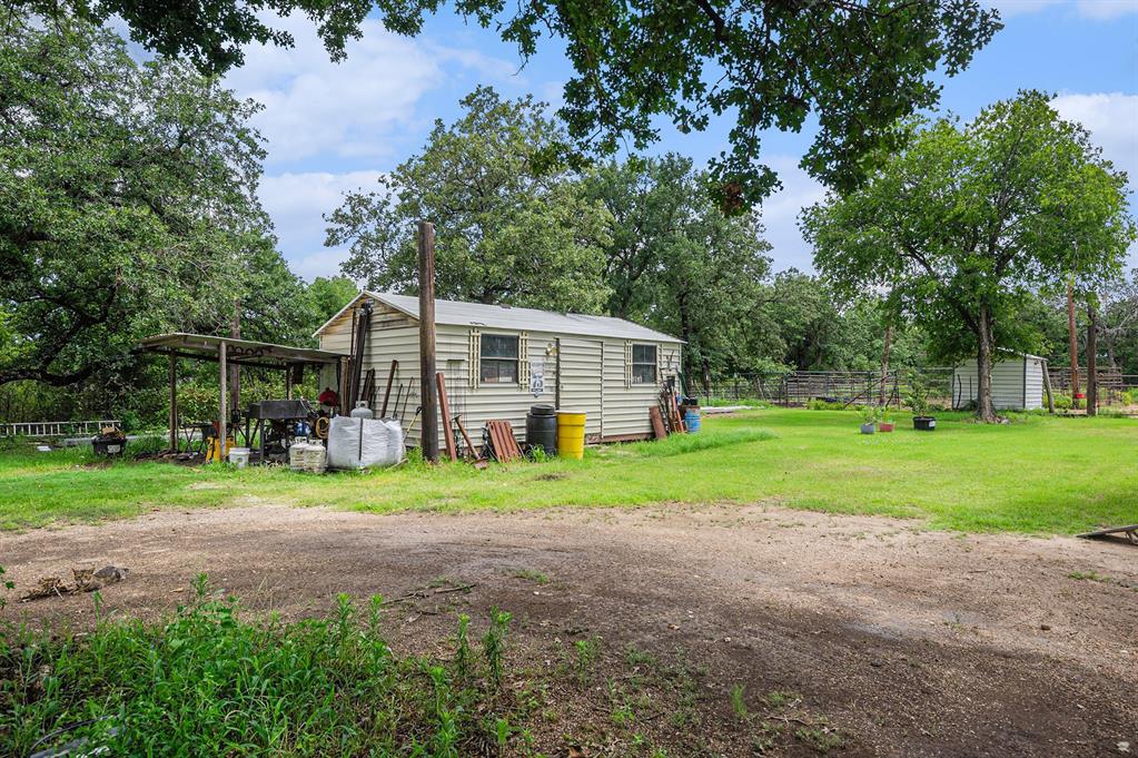 150 County 2110 Road Whitney, TX 76692 - Photo 19 of 21 a view of a house with backyard and trees