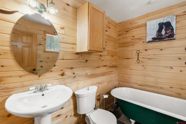 a bathroom with a sink mirror and toilet