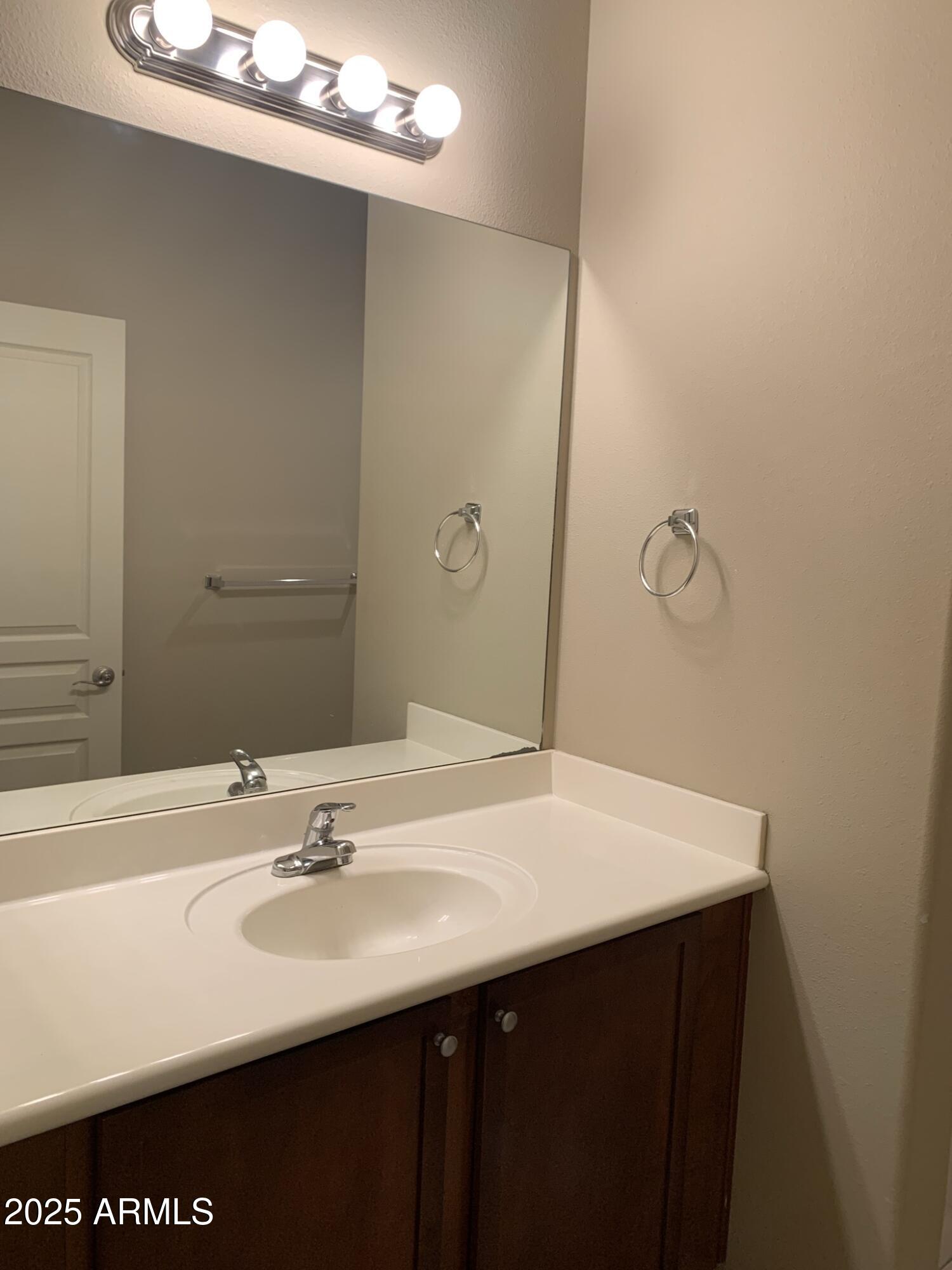 1117 East 8th Street, Unit 3003 Tempe, AZ 85281 - Photo 7 of 16 a bathroom with a sink and a mirror