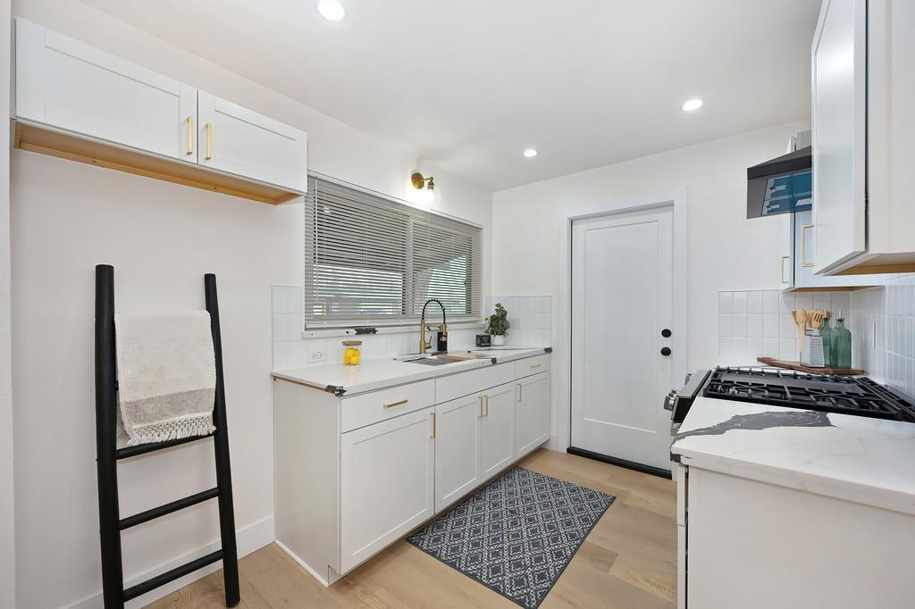 2316 West Swain Road Stockton, CA 95207 - Photo 11 of 46 a kitchen that has a sink and a stove in it