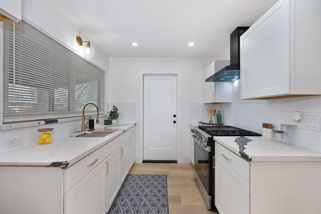 2316 West Swain Road Stockton, CA 95207 - Photo 12 of 46 a kitchen with a sink stove and cabinets