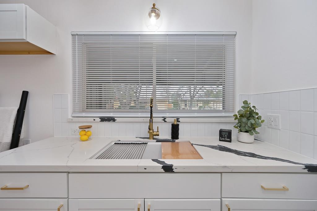 2316 West Swain Road Stockton, CA 95207 - Photo 14 of 46 a kitchen with a window sink and potted plant