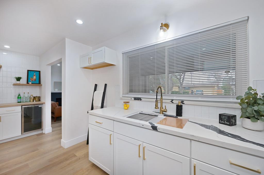 2316 West Swain Road Stockton, CA 95207 - Photo 15 of 46 a kitchen with stainless steel appliances white cabinets a potted plant and a window