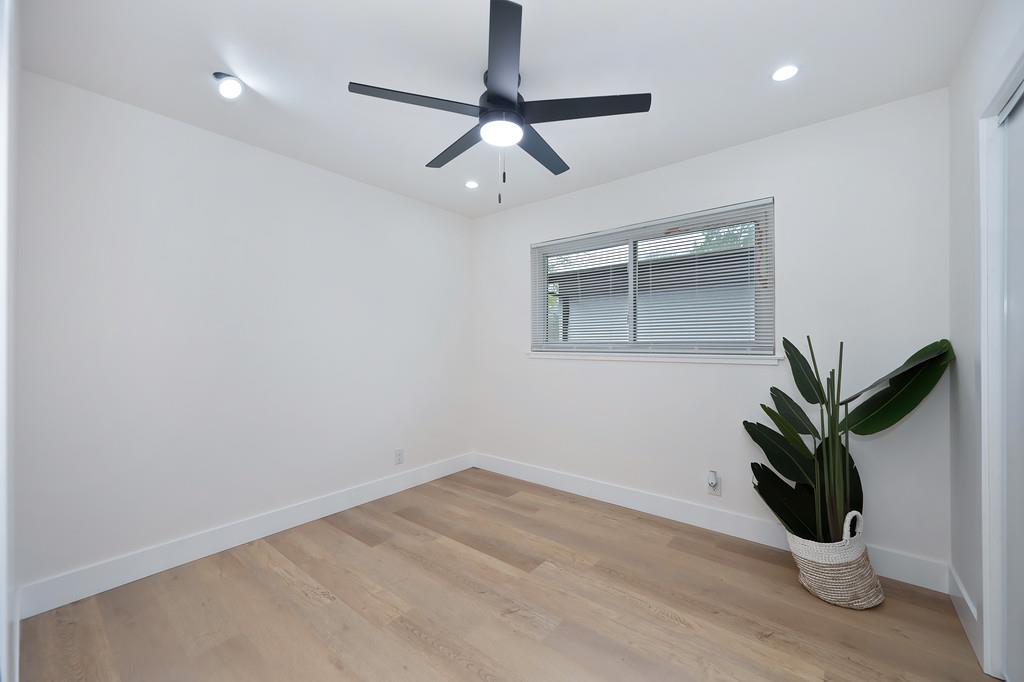 2316 West Swain Road Stockton, CA 95207 - Photo 32 of 46 a view of a room with wooden floor and potted plant