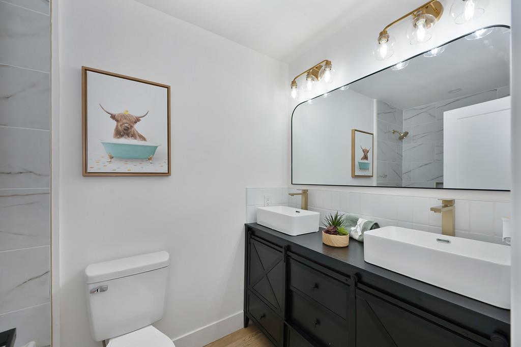 2316 West Swain Road Stockton, CA 95207 - Photo 33 of 46 a bathroom with a sink and a mirror