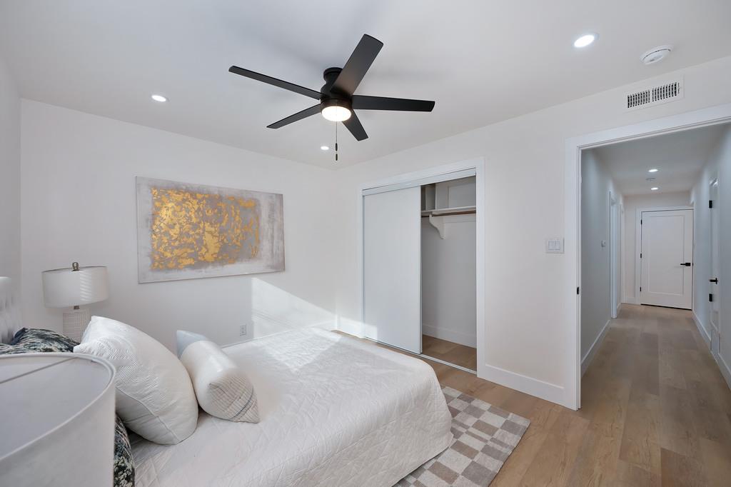 2316 West Swain Road Stockton, CA 95207 - Photo 36 of 46 a bedroom with a large bed and a chandelier