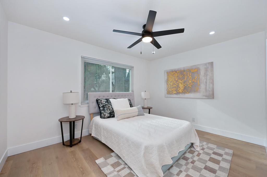 2316 West Swain Road Stockton, CA 95207 - Photo 40 of 46 a bedroom with a large bed and a ceiling fan