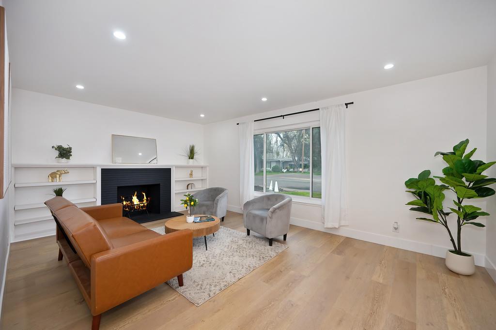 2316 West Swain Road Stockton, CA 95207 - Photo 7 of 46 a living room with furniture and a fireplace