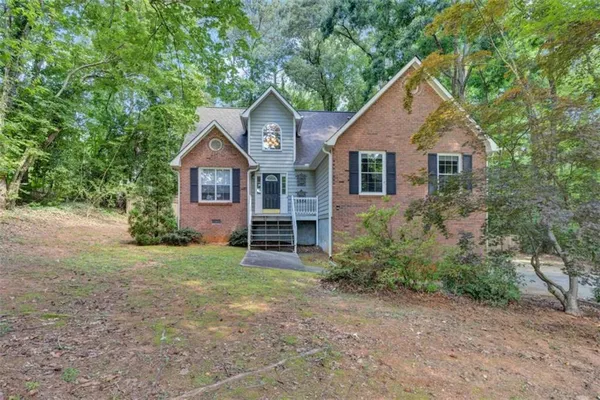 a front view of a house with garden