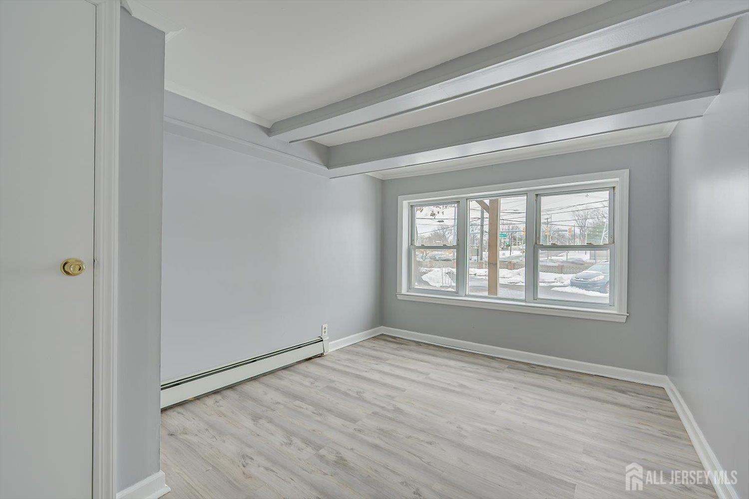 2 Garfield Park Edison, NJ 08837 - Photo 15 of 21 a view of an empty room with wooden floor and a window