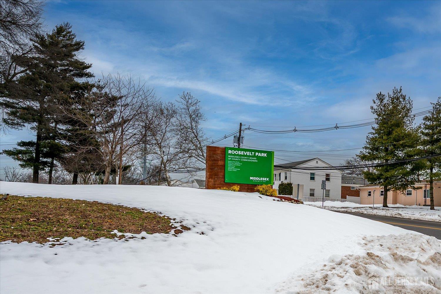 2 Garfield Park Edison, NJ 08837 - Photo 20 of 21 a view of a white house with a yard covered with snow in the background